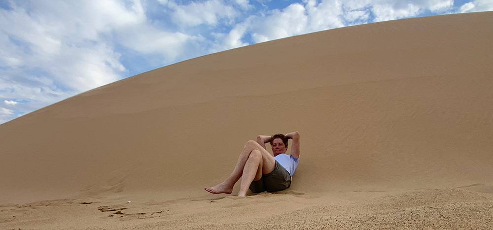 selfie of me sitting on a sand dune